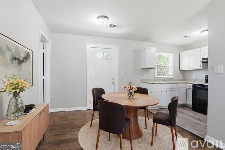 A kitchen with a table and chairs in the middle of the room.