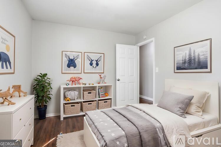 A bedroom with a bed, a dresser, and a shelf with baskets and a plant.