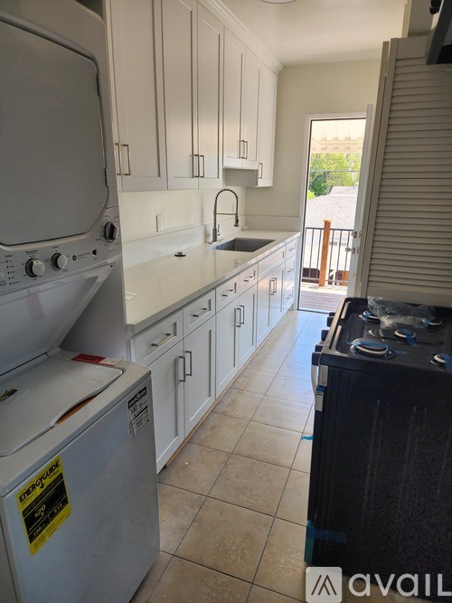 A kitchen with a stove top oven and a dishwasher.