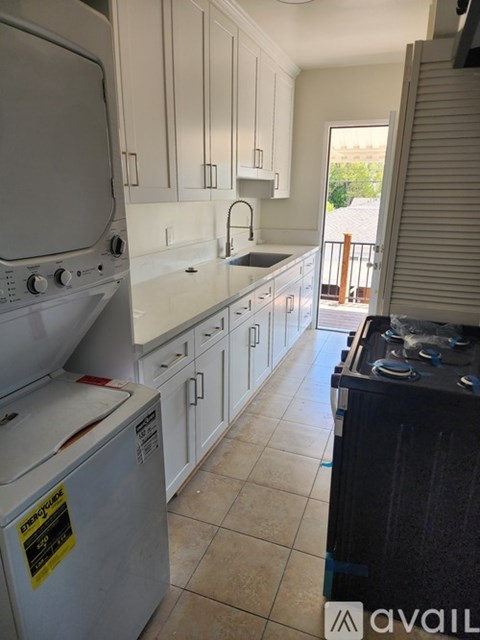 A kitchen with a stove top oven and a dishwasher.