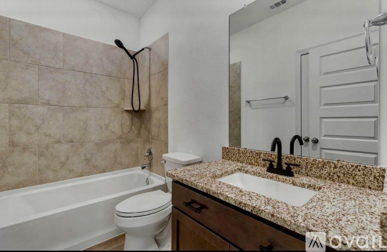A bathroom with a white toilet, a sink, and a bathtub.