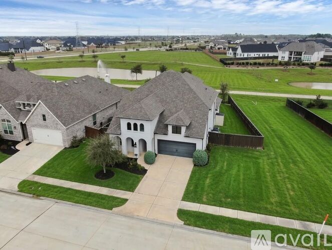 A house with a large front yard is for sale.