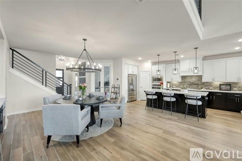 A modern kitchen with a dining table and chairs.