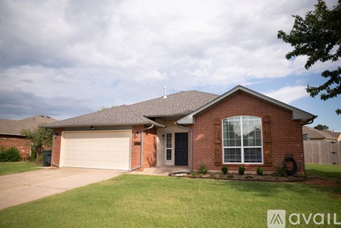 A house with a brown roof and a white garage door.