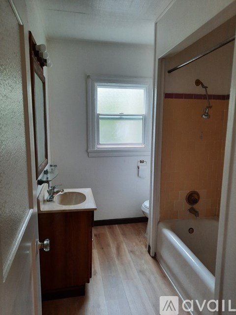 A small bathroom with a sink, toilet, and bathtub.