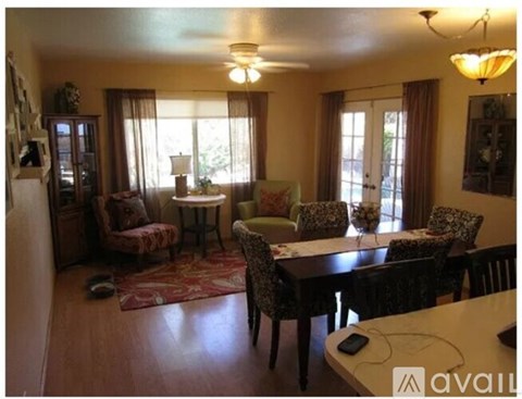 A living room with a dining table and chairs.