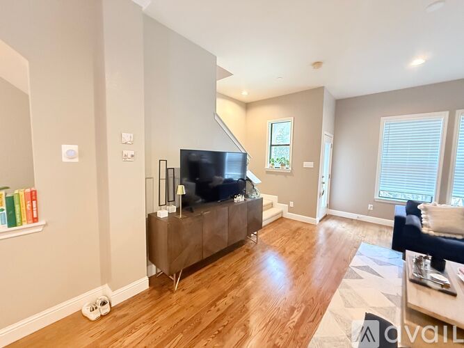 A living room with a television and a couch.