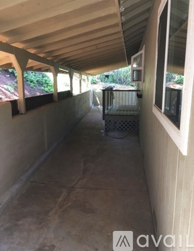 A patio area with a grill and a table.