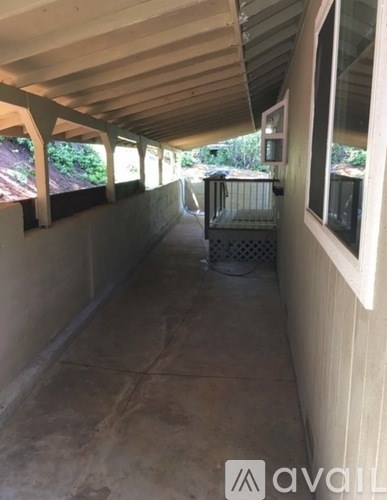 A patio area with a grill and a table.