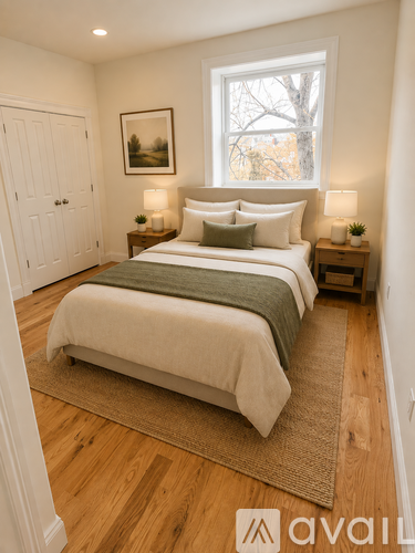 A bedroom with a large bed and two nightstands.