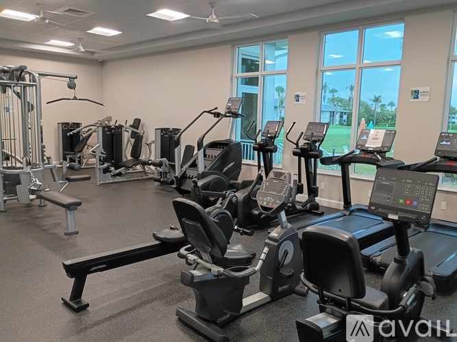 A gym with treadmills, elliptical machines, and other cardio equipment.