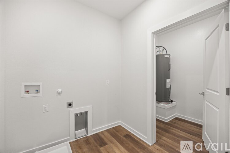 A room with a white wall and a door on the right side.