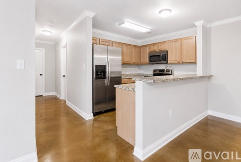 A kitchen with wooden cabinets and a white island.