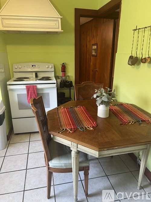 A kitchen with a table set for a meal.