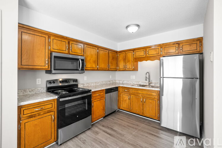 A kitchen with wooden cabinets and stainless steel appliances.