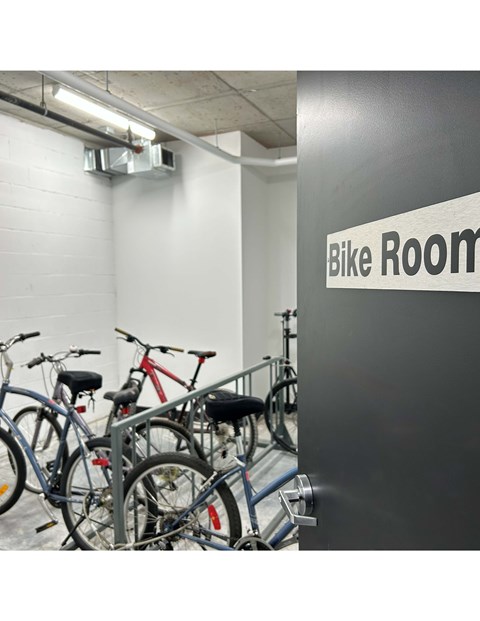 A bike room with a sign and bikes.