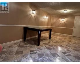 A room with a table and wall lights.