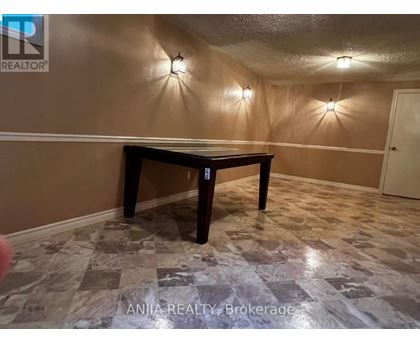 A room with a table and wall lights.