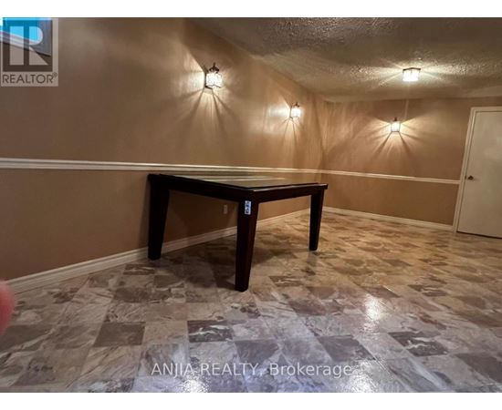 A room with a table and wall lights.