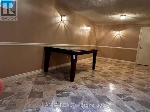 A room with a table and wall lights.