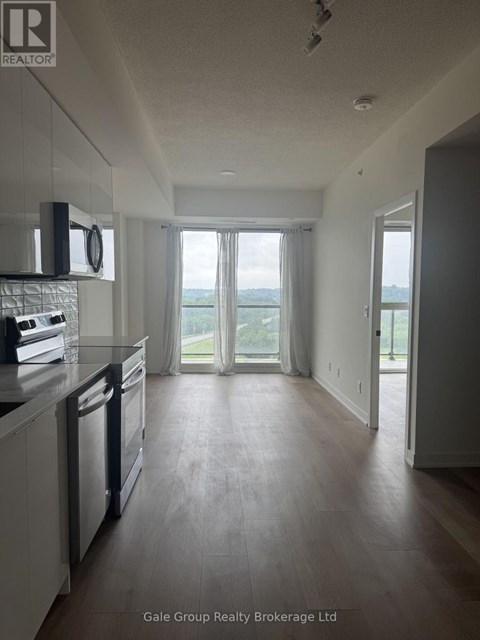 A spacious kitchen with a dishwasher and a window overlooking the outdoors.