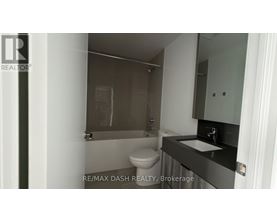 A bathroom with a toilet, sink and shower.