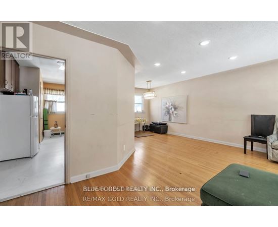 A living room with a couch, chair, and television.