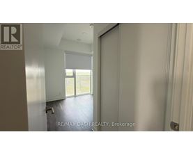 A room with a sliding glass door leading to a balcony.