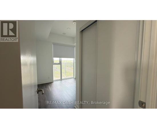 A room with a sliding glass door leading to a balcony.
