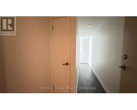 A hallway with a door on the left and a door on the right.