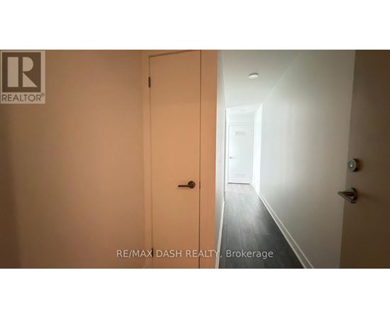 A hallway with a door on the left and a door on the right.