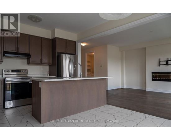 A kitchen with a stove top oven and a refrigerator.