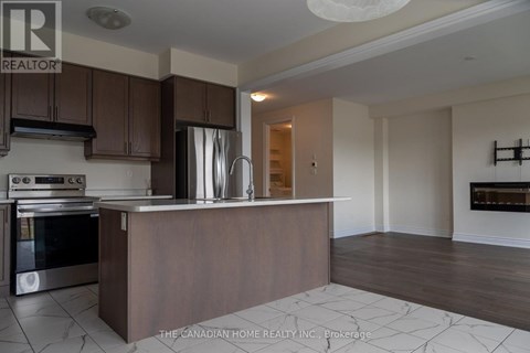 A kitchen with a stove top oven and a refrigerator.