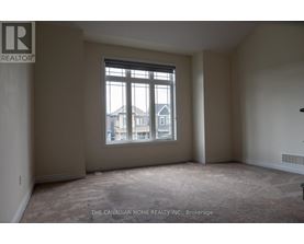 A room with a large window and a view of a building outside.