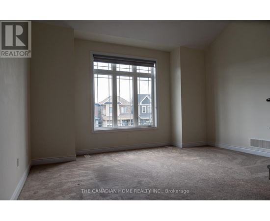 A room with a large window and a view of a building outside.