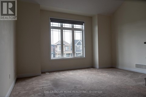A room with a large window and a view of a building outside.