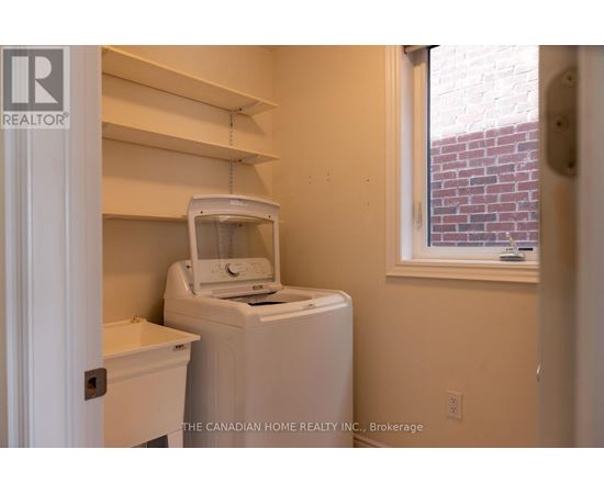 A small laundry room with a washer and dryer.