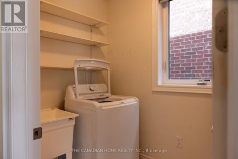 A small laundry room with a washer and dryer.