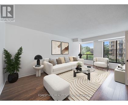 A living room with a white couch and a coffee table.