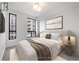 A bedroom with a large bed and a window overlooking a building.