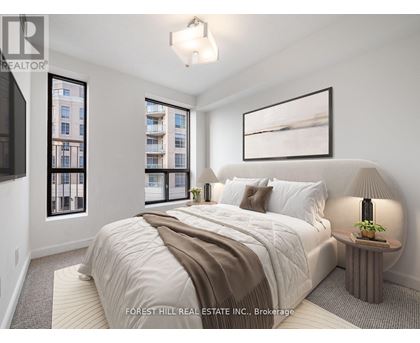 A bedroom with a large bed and a window overlooking a building.