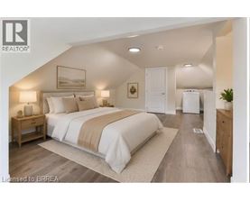 A bedroom with a large bed and a wooden nightstand.