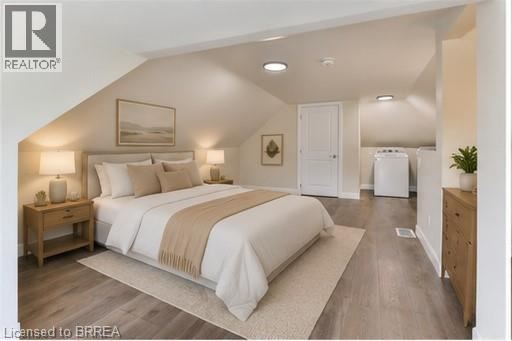 A bedroom with a large bed and a wooden nightstand.