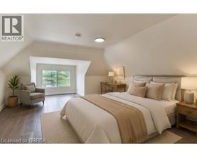 A bedroom with a large bed and a chair by a window.
