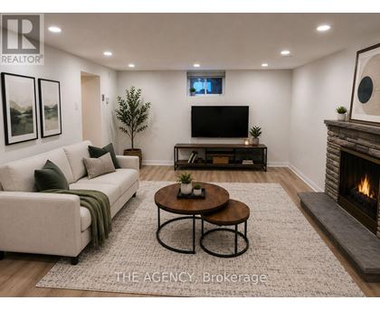 A living room with a couch, coffee table, and fireplace.