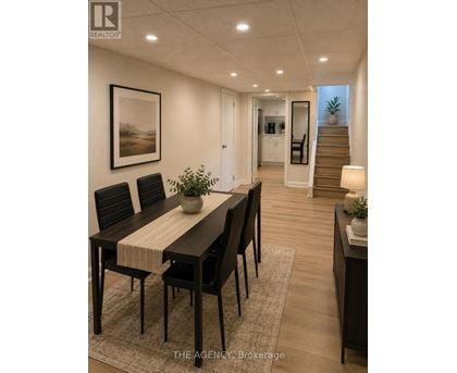 A dining room with a table set for four.