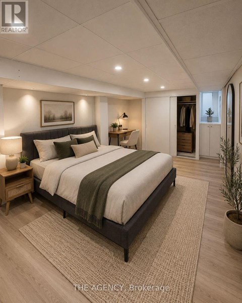 A bedroom with a large bed and a rug on the floor.