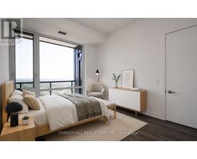 A bedroom with a large bed and a view of the ocean.