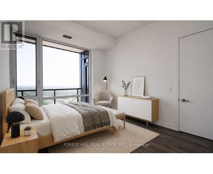 A bedroom with a large bed and a view of the ocean.