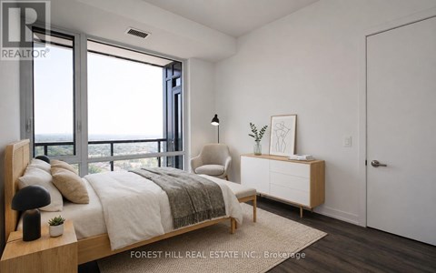 A bedroom with a large bed and a view of the ocean.